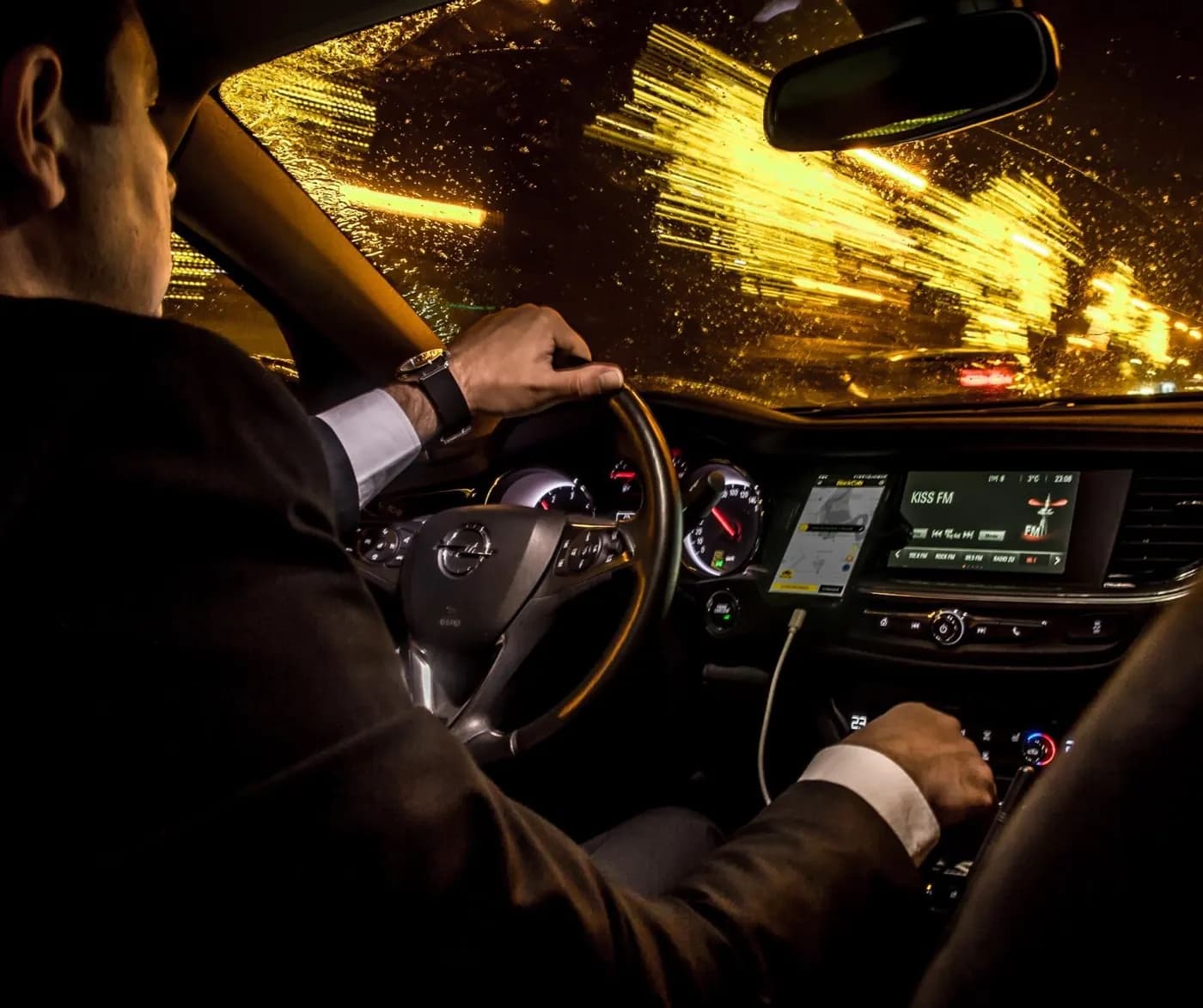 A BlackCab partner driving at night, the BlackCab driver app on the dashboard